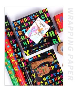 Detail of Happy Birthday wrapping paper rolls with unicorn gift cards and hemp ropes