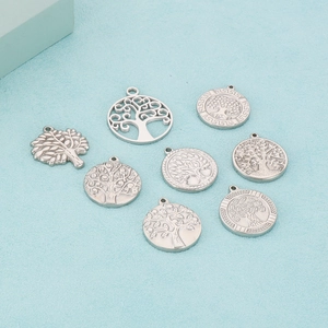 Macro view of eight distinct silver stainless steel tree of life charms for DIY jewelry