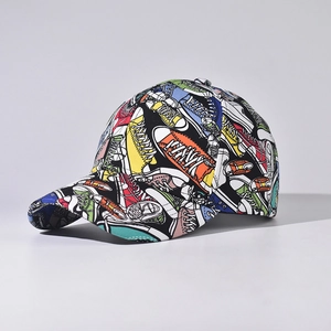 Detail of baseball cap featuring colorful cartoon sneaker graffiti and curved brim