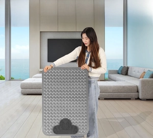 Detail of grey bathroom mat featuring suction cups and a cloud-shaped foot massage zone