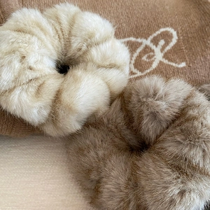 Plush faux mink fur hair scrunchies in cream and brown on brown knit background
