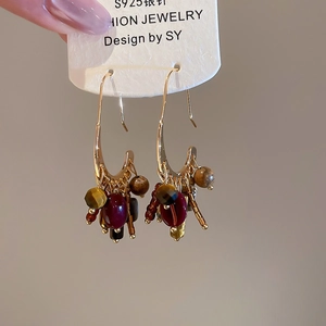 Detail of 18k gold plated earrings with S925 silver needle and bohemian stone tassels