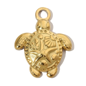 Detailed view of turtle pendant with embossed starfish and shell in gold steel