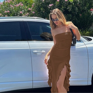 Detail view of brown tube dress with ruching and asymmetrical ruffle high slit