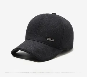 Close-up of side metal Sports emblem on textured dark grey winter baseball cap