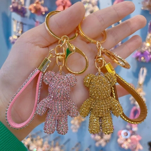 Sparkling crystal rhinestone teddy bear keychains in pink and gold with leather straps