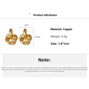 Detail view of twisted metal hoop earrings showing 1.4cm dimensions and copper material