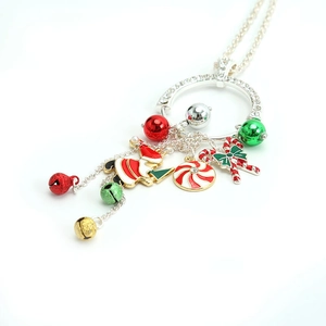 Christmas charm necklace with Santa, candy cane, and bells on a silver chain