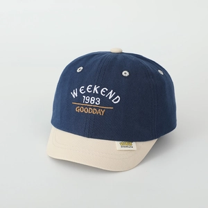 Detail of kids baseball cap with weekend embroidery and soft color-block brim