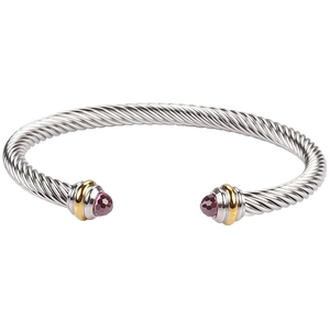 Detail of silver twisted cable bracelet with gold accents and purple gemstone ends