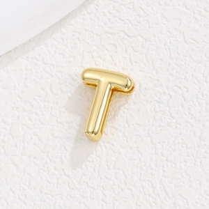 Macro shot of a polished gold letter T pendant for DIY 10mm slide charm bracelets