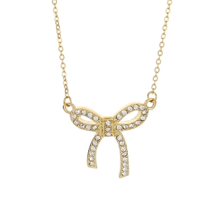 Elegant gold stainless steel necklace with a sparkling crystal bow pendant on white background