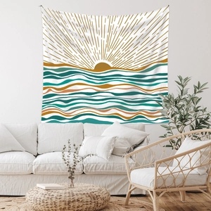 Detail of bohemian tapestry featuring abstract sun and ocean wave patterns over a sofa