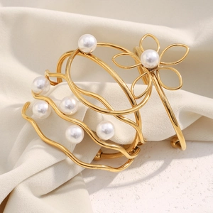Detail of 18K gold plated layered bangle with pearl flower and wave line accents
