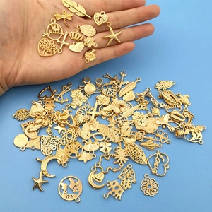 Detailed view of mixed gold alloy pendants including hearts and stars for DIY jewelry making