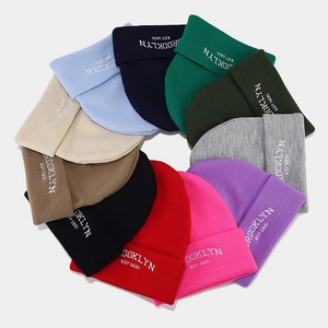 Variety of colorful oversized knitted beanies with Brooklyn embroidery in a circular layout