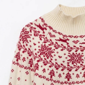 Cozy white Christmas knit sweater featuring red reindeer and snowflake jacquard patterns