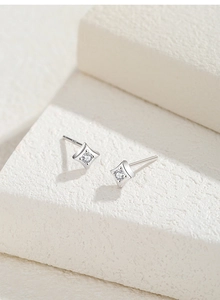 Detailed macro view of S925 sterling silver star stud earrings with round cubic zirconia