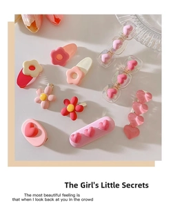 Flat lay of cute Y2K pink flower and heart hair clips with tulip petal decoration