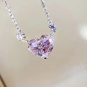 Macro shot of heart-shaped pink gemstone necklace with brilliant claw-set sparkling stones