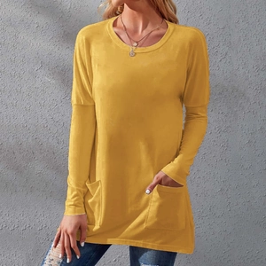Detail of loose fit long sleeve mustard yellow T-shirt dress with functional side pockets
