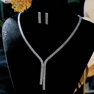 Sparkling silver zircon fringe necklace and earrings set displayed on a black velvet mannequin