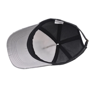 Detail view of cotton baseball cap interior showing sweatband and metal adjustment strap