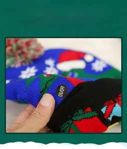 Close-up of the LED light ON/OFF switch and battery compartment on the knitted Christmas hat