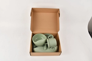 Detailed set of green silicone baby feeding supplies including suction bowl and plate