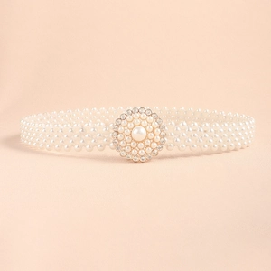 Detail of white multi-strand pearl belt featuring a round rhinestone centerpiece buckle