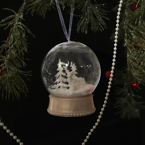 Christmas clear globe ornament featuring a miniature snowy forest with a champagne gold base