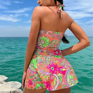 Bohemian paisley print two-piece swimsuit with halter top and skirt in vibrant orange