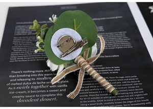 Detail of wedding boutonniere back with metal safety pin and crocodile clip fastener
