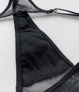 Close-up of black mesh stitching and cotton fabric detail on the scorpion thong underwear
