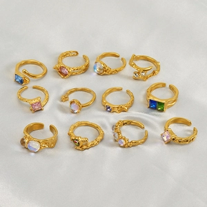 Irregular stainless steel moonstone ring set with hammered gold finish and colorful stones