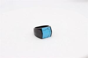Close-up of men's square blue turquoise inlay on a wide black stainless steel ring