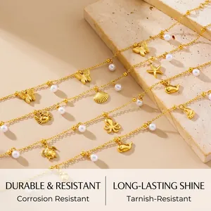 Detailed view of gold starfish and sea turtle charms with pearls on chain anklets