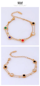 Detailed view of colorful double-layer gold chain bracelet with round enamel inlays