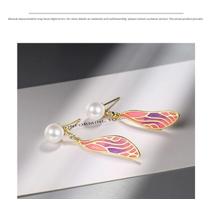 Detail of pink gradient enamel wing earrings with pearls and subtle gold crystal accents