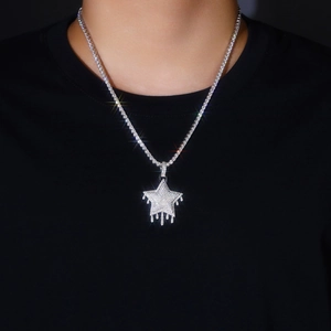 Iced-out crying star pendant in S925 silver with tennis chain on black clothing