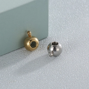 Macro detail of 18K gold and silver plated stainless steel beads with jump rings for jewelry