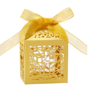 Detail view of a golden hollow candy box featuring an elegant laser-cut cross design