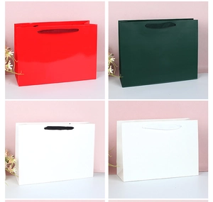 Variety of premium paper gift bags in red, dark green and white with durable handles