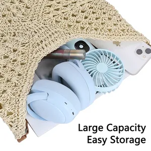 Spacious beige woven straw tote bag filled with lifestyle items like blue headphones