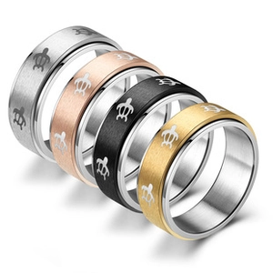 Detail view of stacked brushed steel rings with turtle patterns in four colors