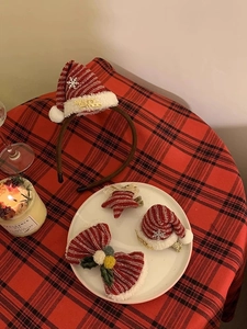 Close-up of red plush Christmas headband and clips with golden Merry Xmas text