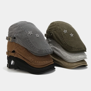 Detail of assorted cotton flat caps featuring silver star studs and adjustable metal buckles