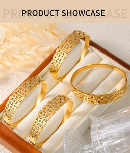 Detail of gold-plated hollow geometric bracelets with inlaid crystals in a jewelry box