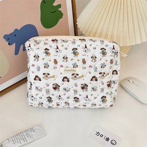 Detailed view of quilted cotton cosmetic bag with cute cartoon puppy patterns