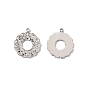 Detail of round woven metal pendant with mirror finish and smooth back for jewelry making